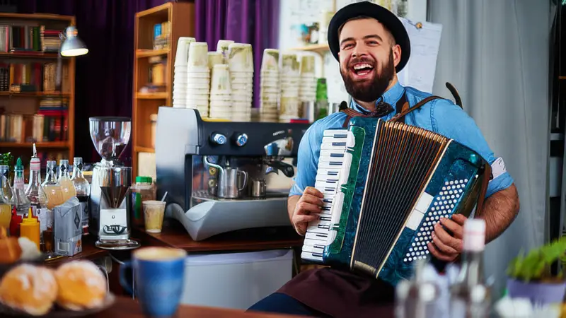 musician at harmony cafe in ashville nc playing accordian