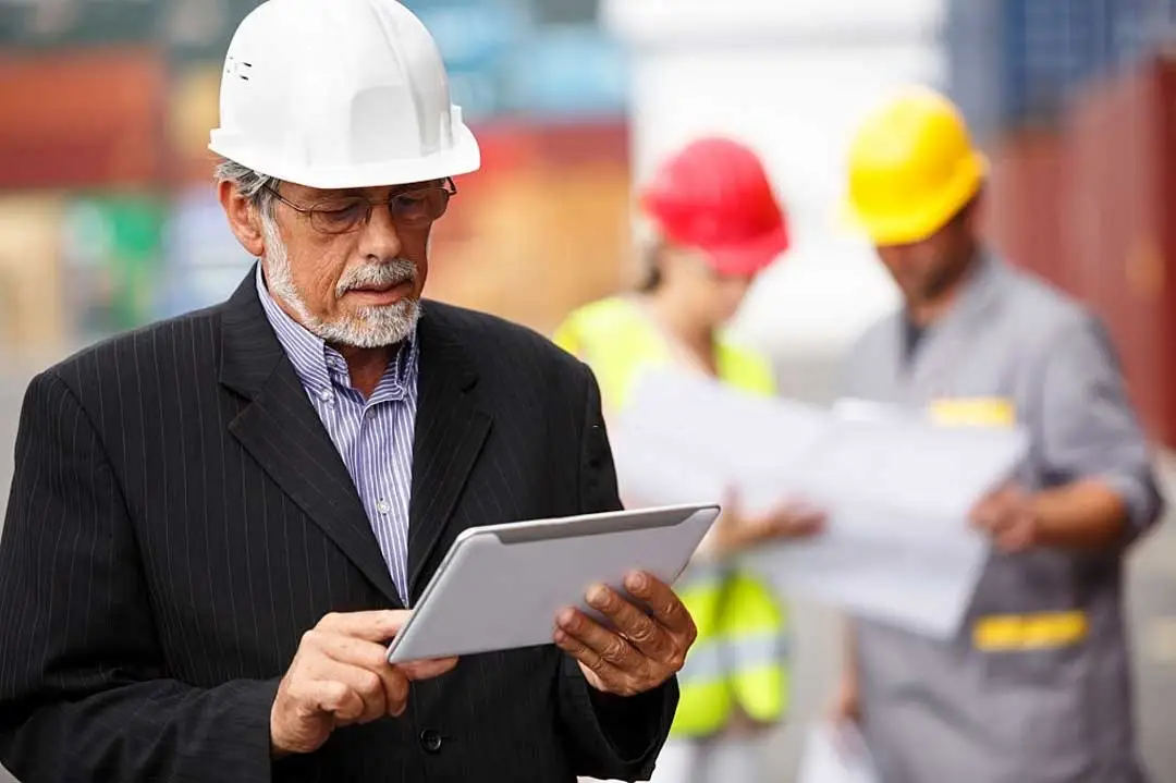 project manager with digital tablet calculating construction price in baton rouge