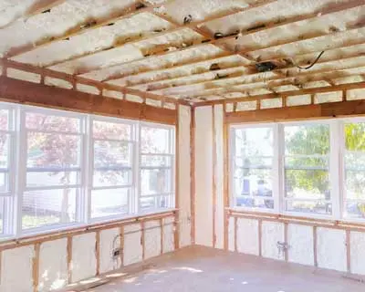 wooden studs and sprayfoam insulation in home under construction in denham springs louisiana