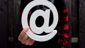 email concept person holding at symbol 1