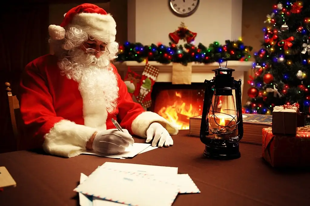 santa claus writing marketing letters to children