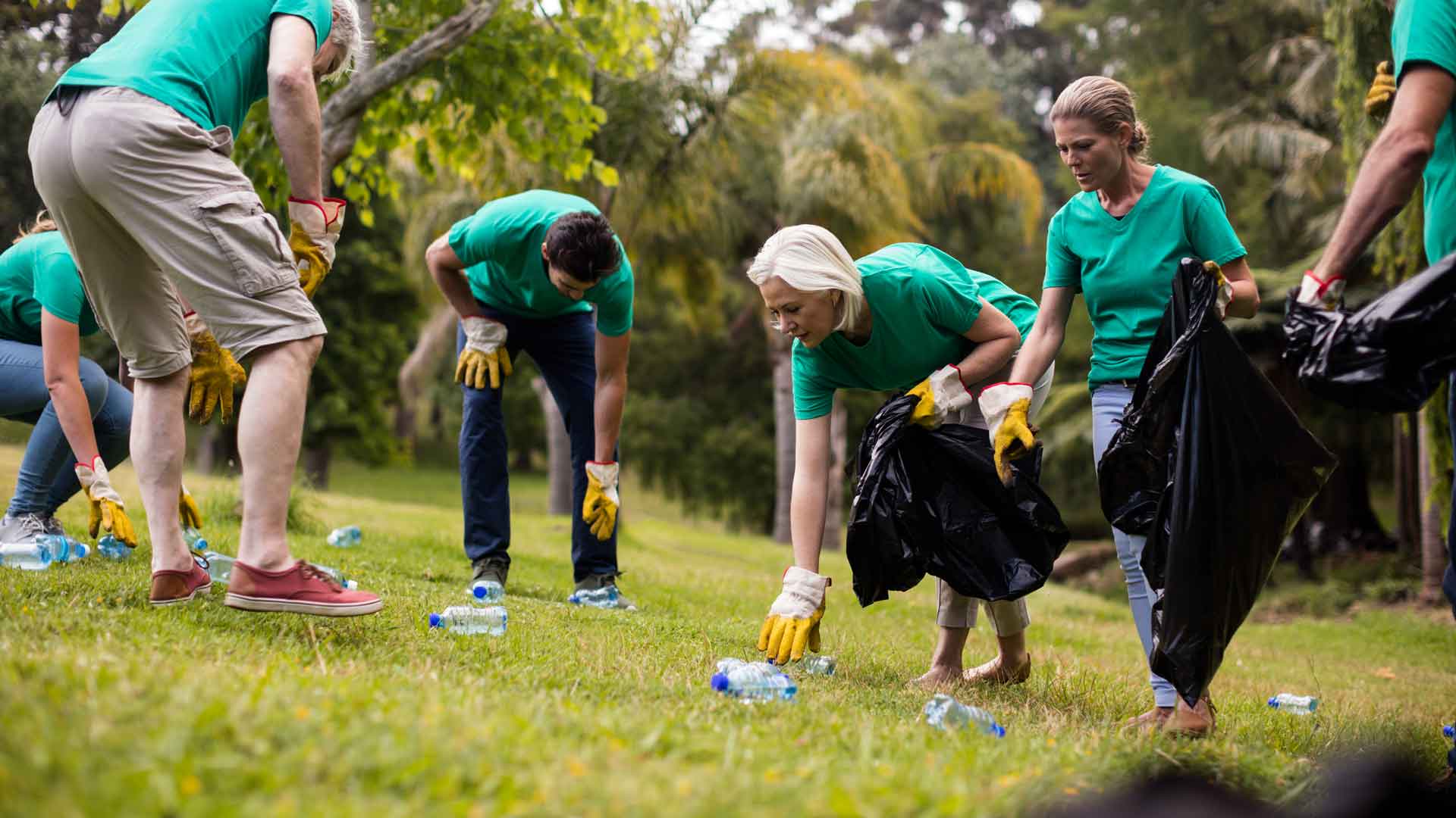 team of nonprofit volunteers picking up litter