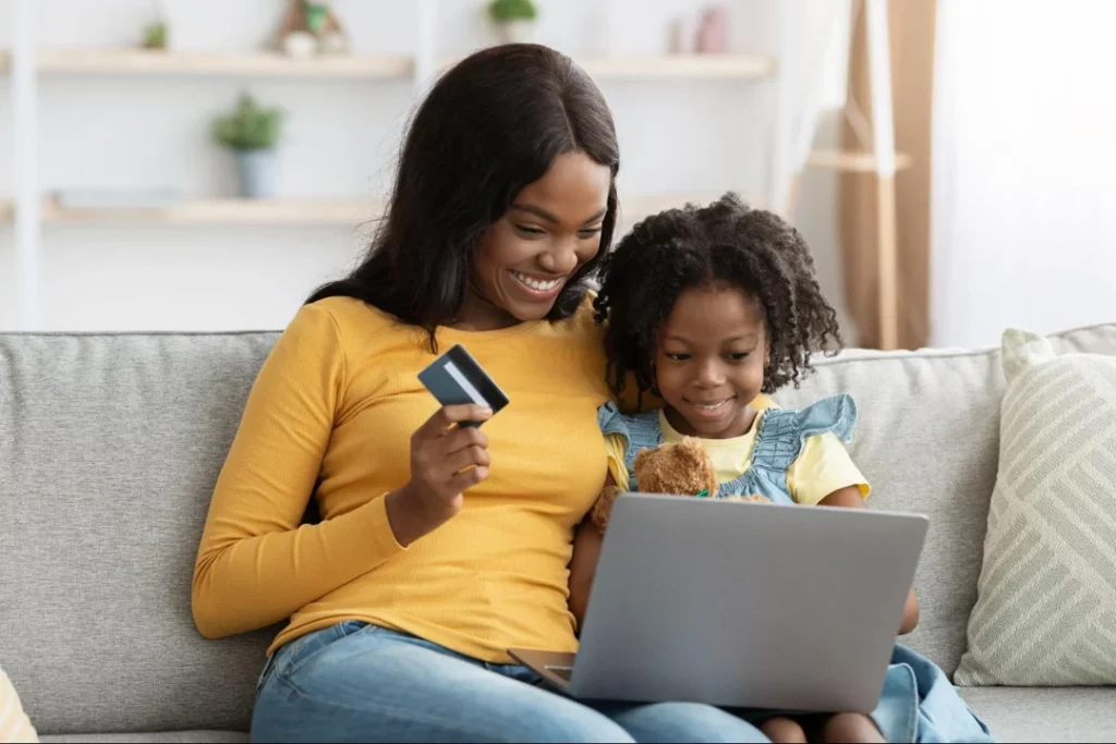 african american mom daughter making purchase from small business website