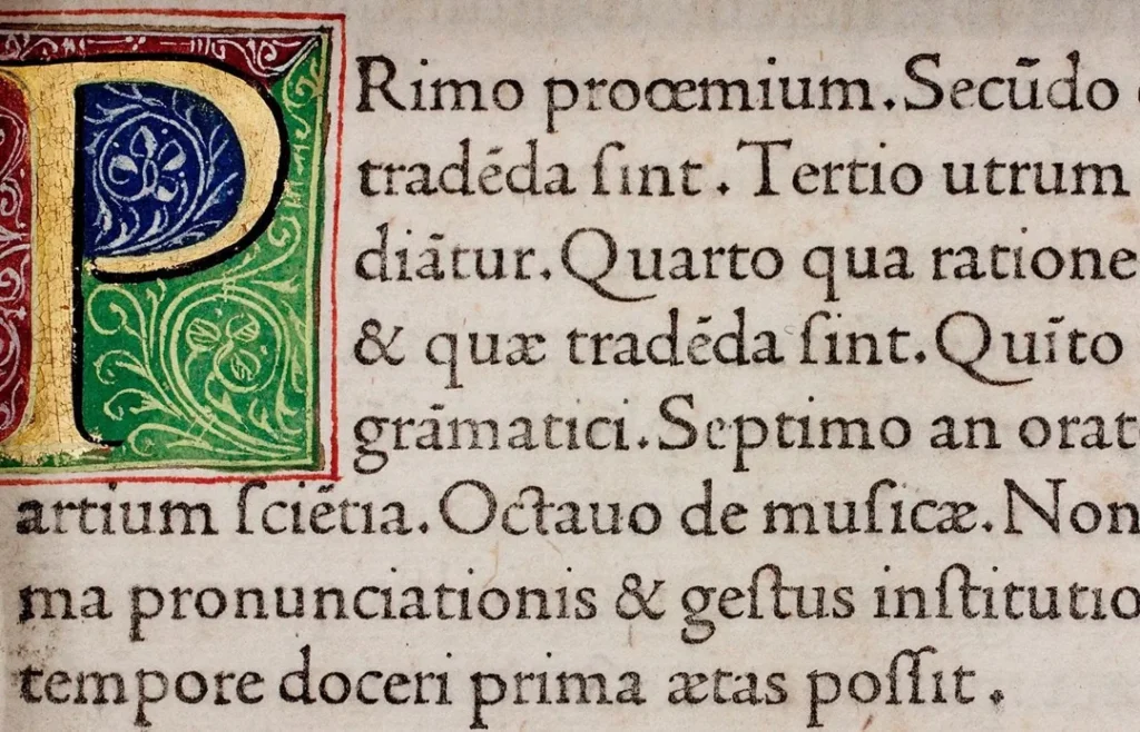 decorative illuminated initial with medieval latin text on aged parchment detailing subjects