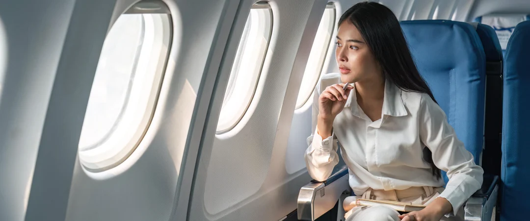 aerojets passenger looking out private jet window